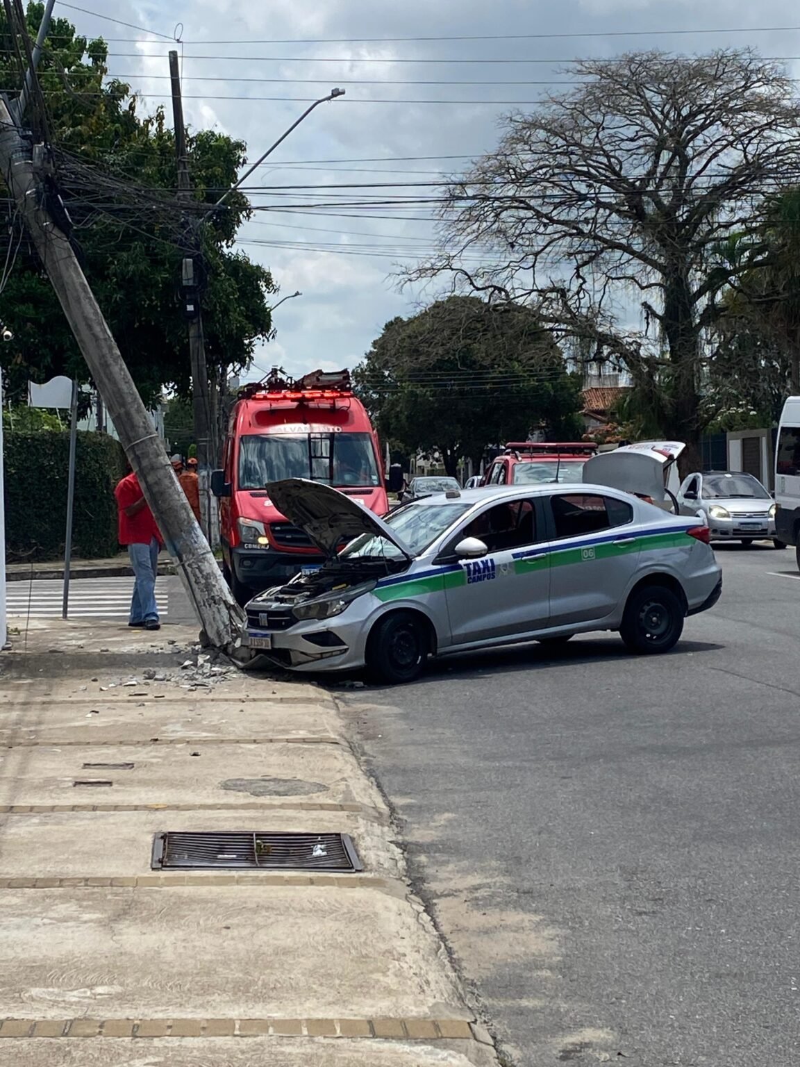 Táxi colide com poste no Flamboyant após motorista se distrair com celular; passageiro fica ferido
